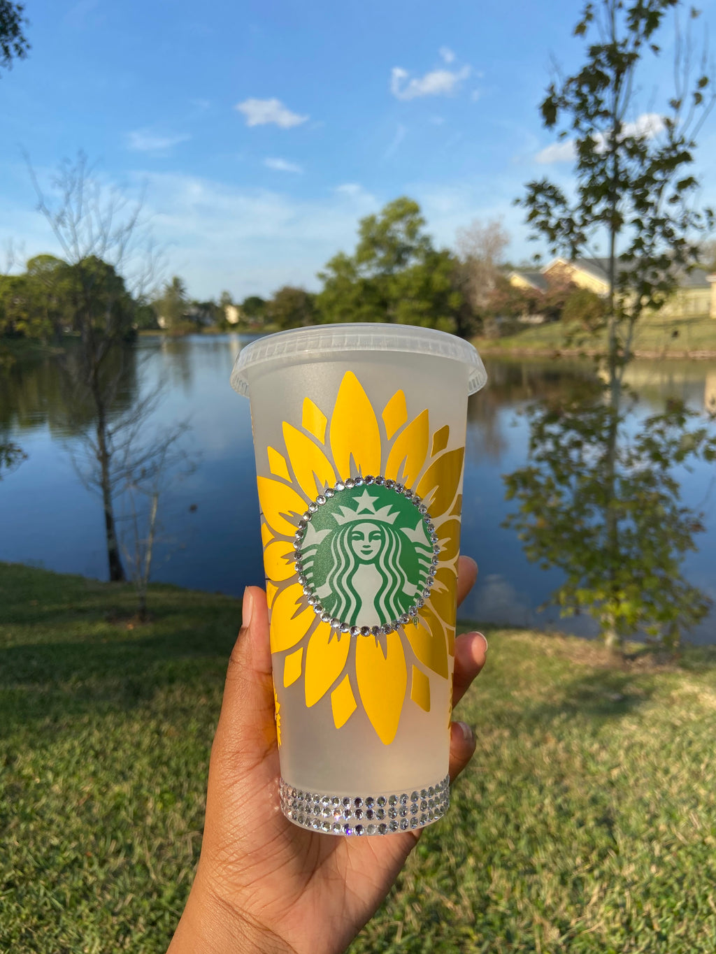 Yellow sunflower cold cup with silver rhinestones going around the Starbucks Logo, surrounding the bottom of the cup, and the lid