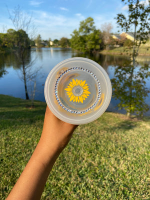 Yellow sunflower cold cup with mini sunflowers going around and rhinestones lid view